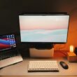 a desk with a laptop and a computer monitor