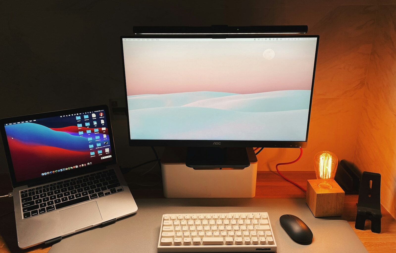 a desk with a laptop and a computer monitor