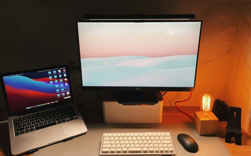 a desk with a laptop and a computer monitor